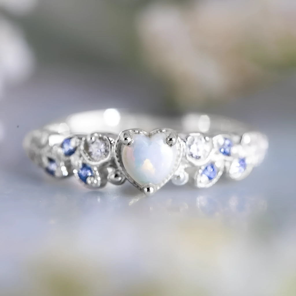 Silver women's ring featuring a heart shape with a floral opal stone in the centre.