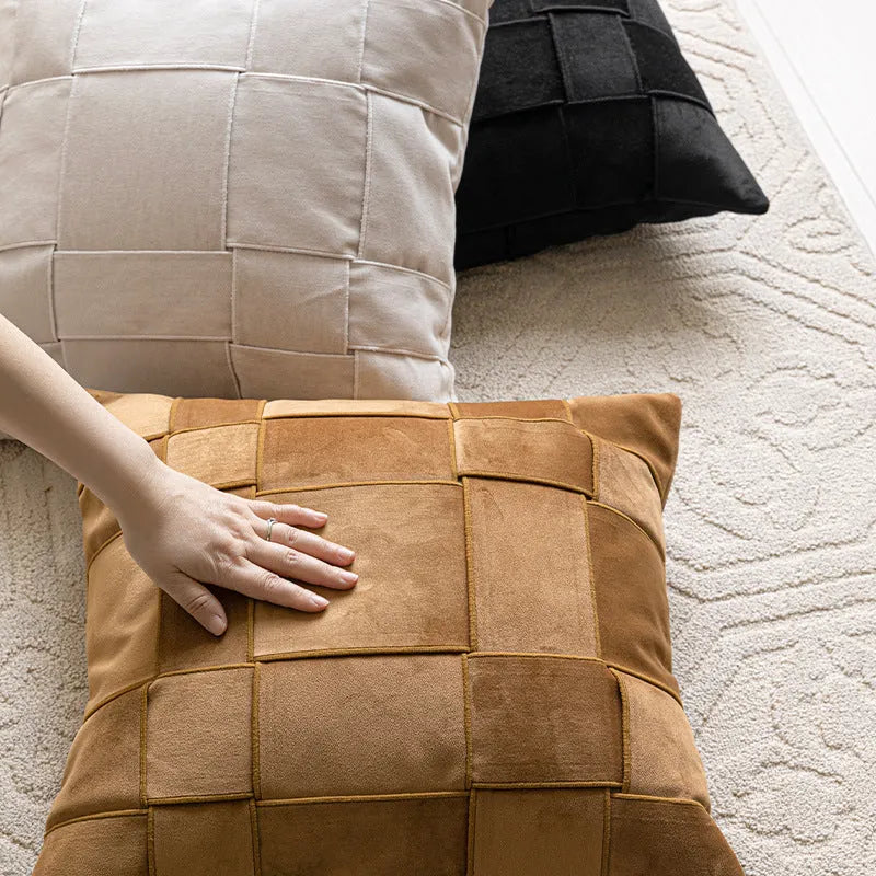 Square 50x50 cm chenille woven pillow cushion in beige colour on a grey sofa.