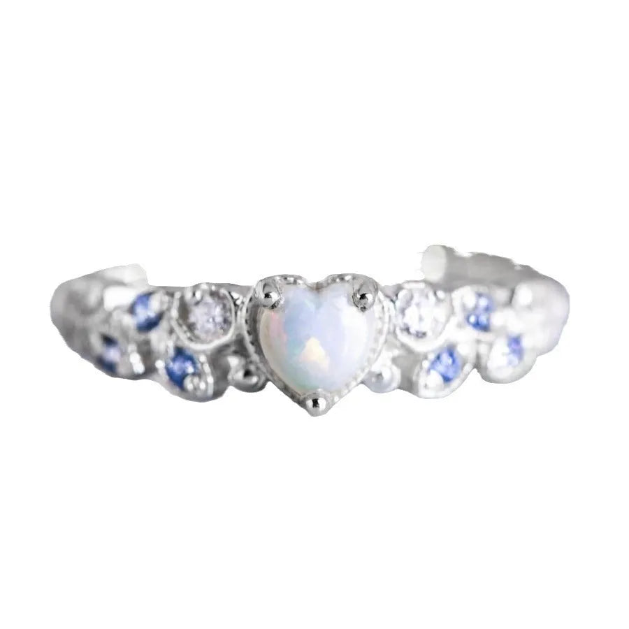 Silver women's ring featuring a heart shape with a floral opal stone in the centre.