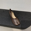 Women's black chunky heel pumps with a horseshoe split toe and round toe design.