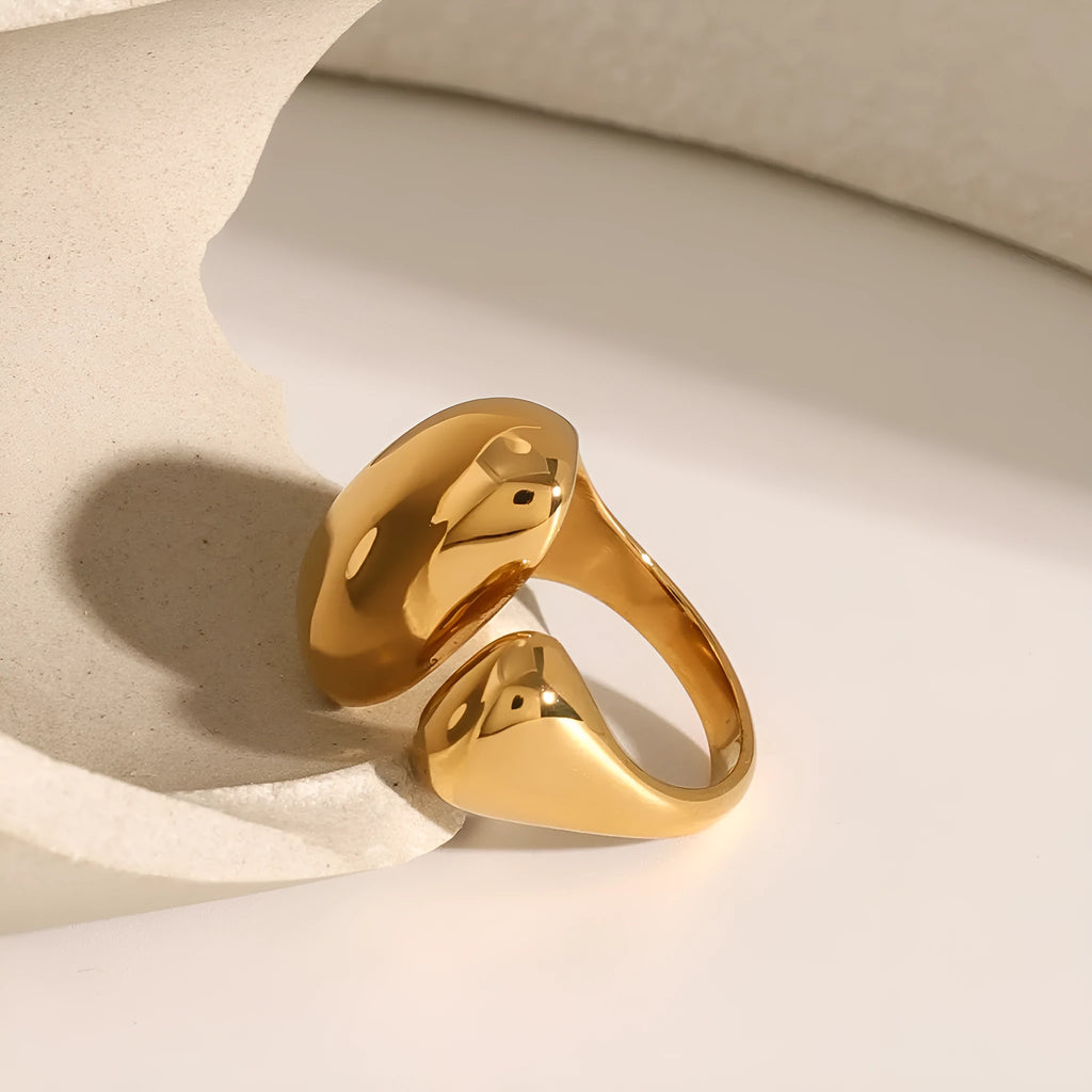 Women's geometric open ring in stainless steel with electroplated finish showing exaggerated angular design