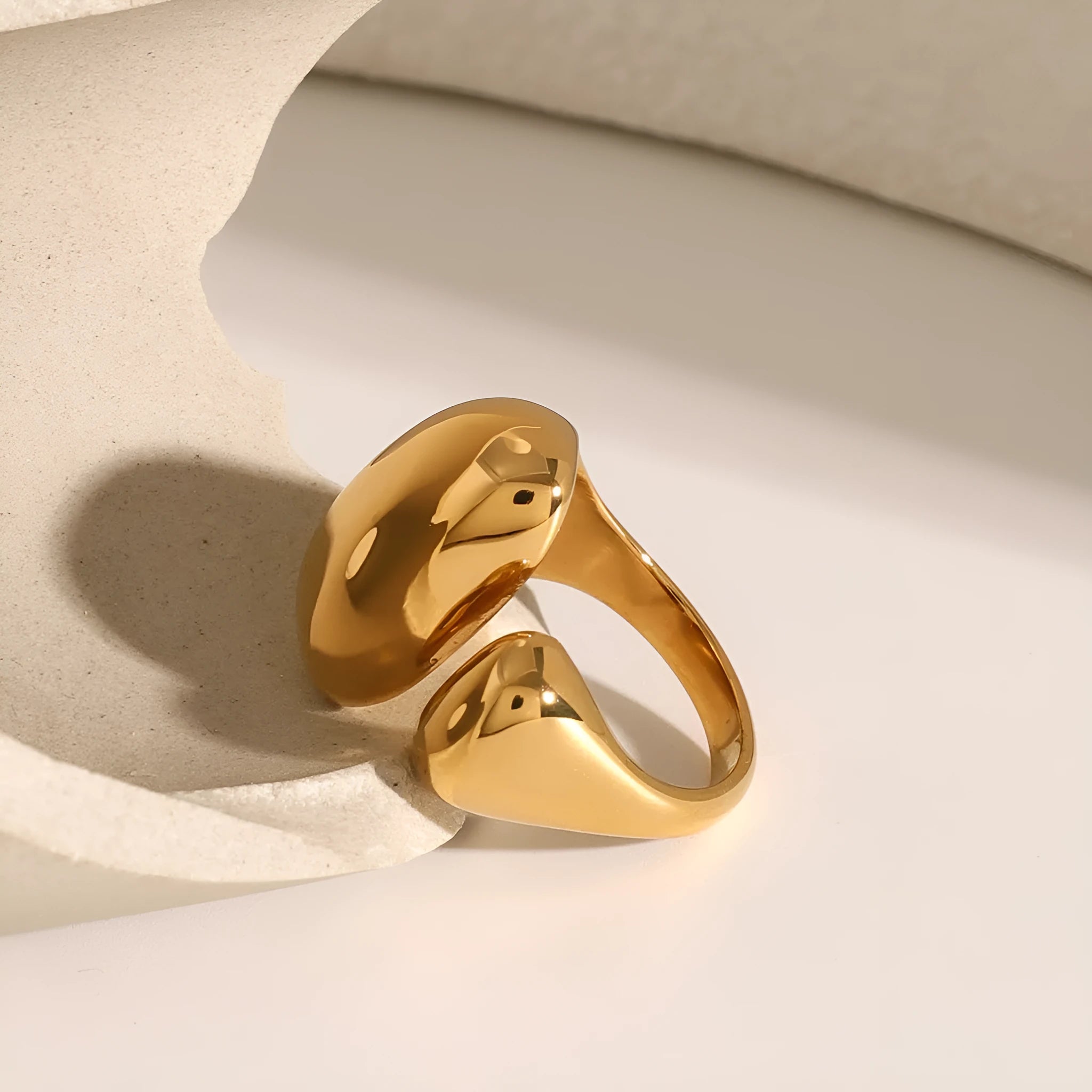 Women's geometric open ring in stainless steel with electroplated finish showing exaggerated angular design