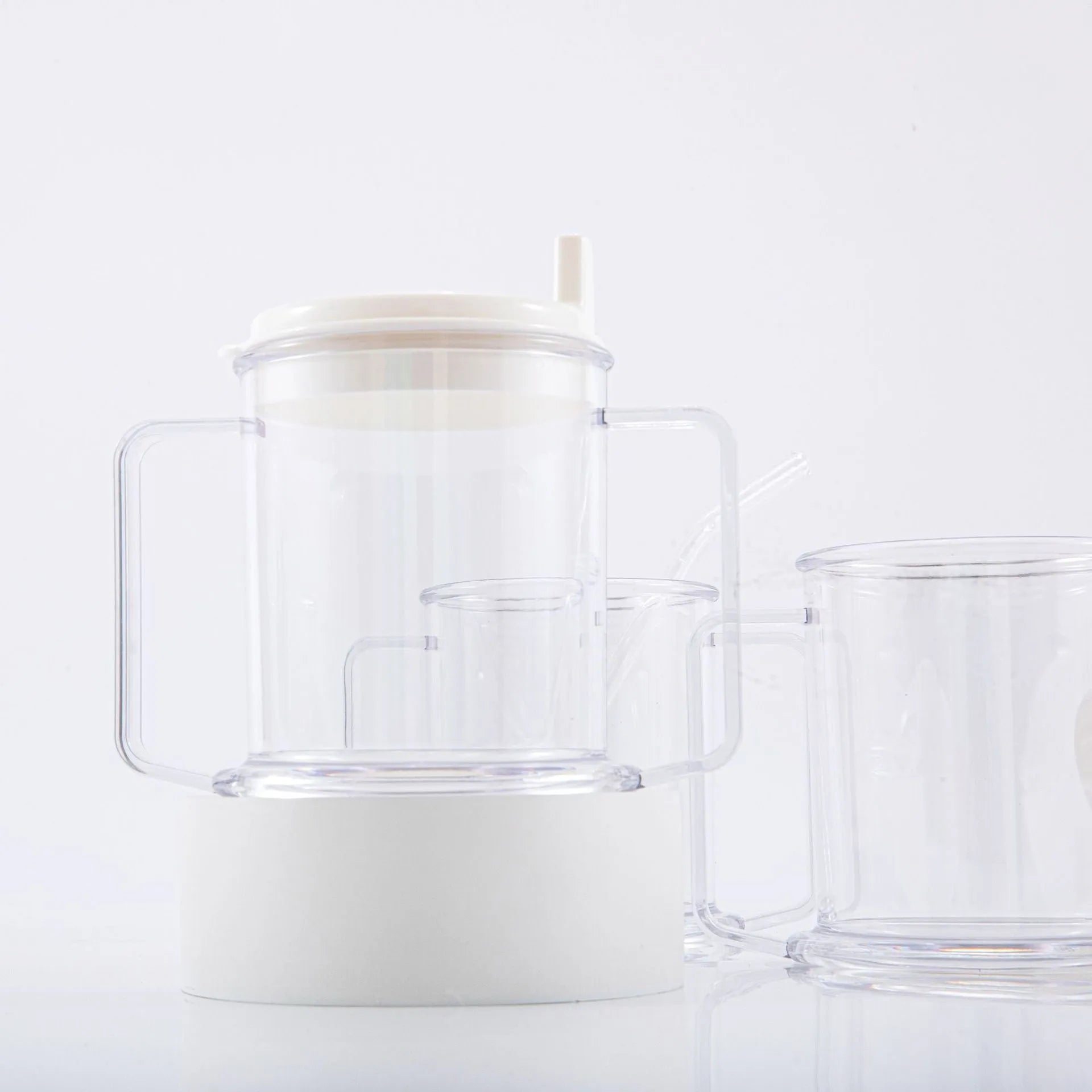 Transparent spill-proof plastic drinking cup showing 14cm height and 12cm diameter