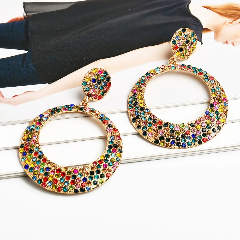 Colourful alloy metal earrings with large round diamond-look pendants in cartoon style