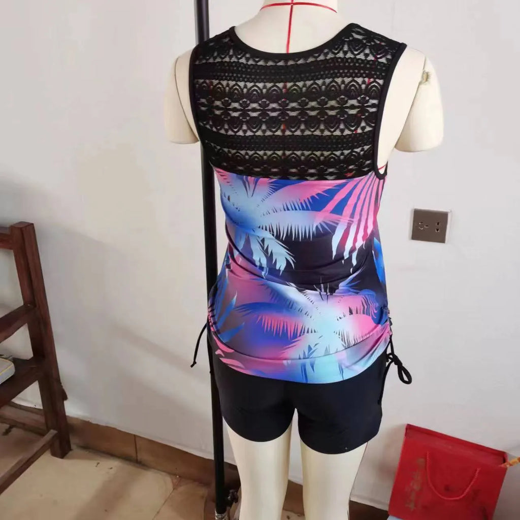 Women's blue printed lace two-piece swimsuit with a sleeveless top and brief shorts.