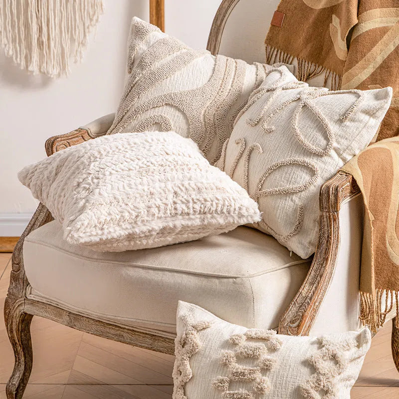 Knitted decorative pillow cover with tassels in a striped print design.