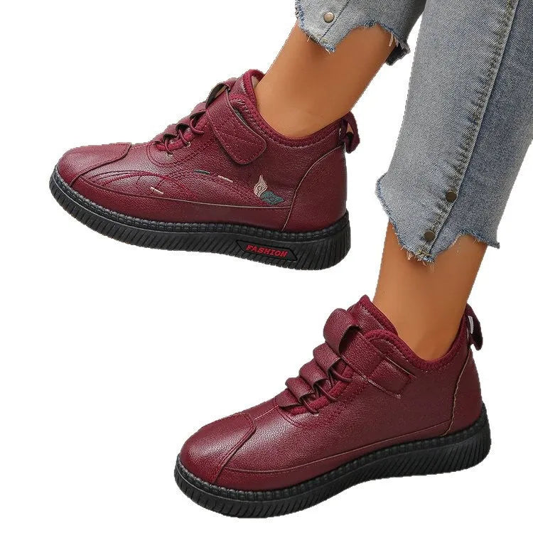 Black and red women's velvet indoor shoes with rubber soles and low tube socks design.