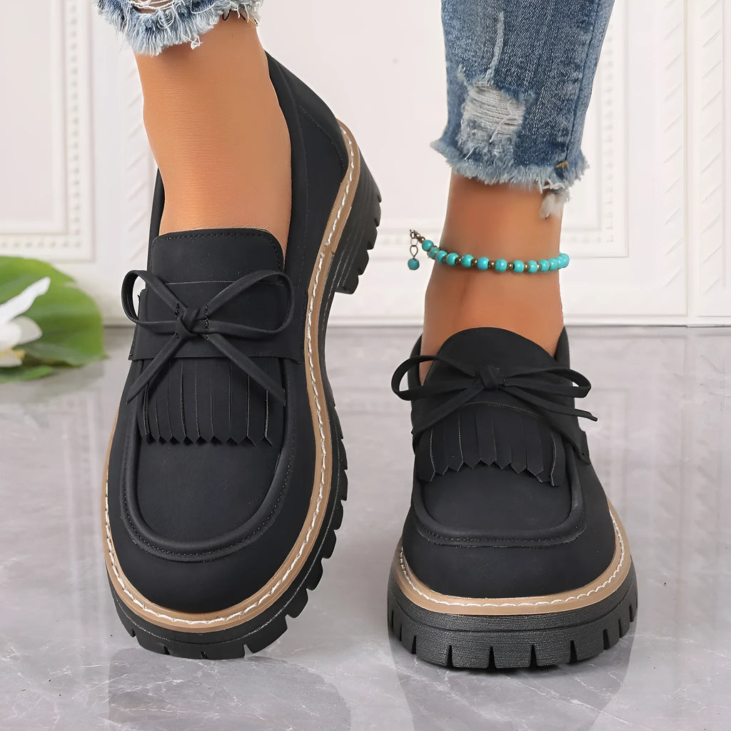 Brown plus size women's loafers with a tassel and bowknot detail on a chunky thick heel.