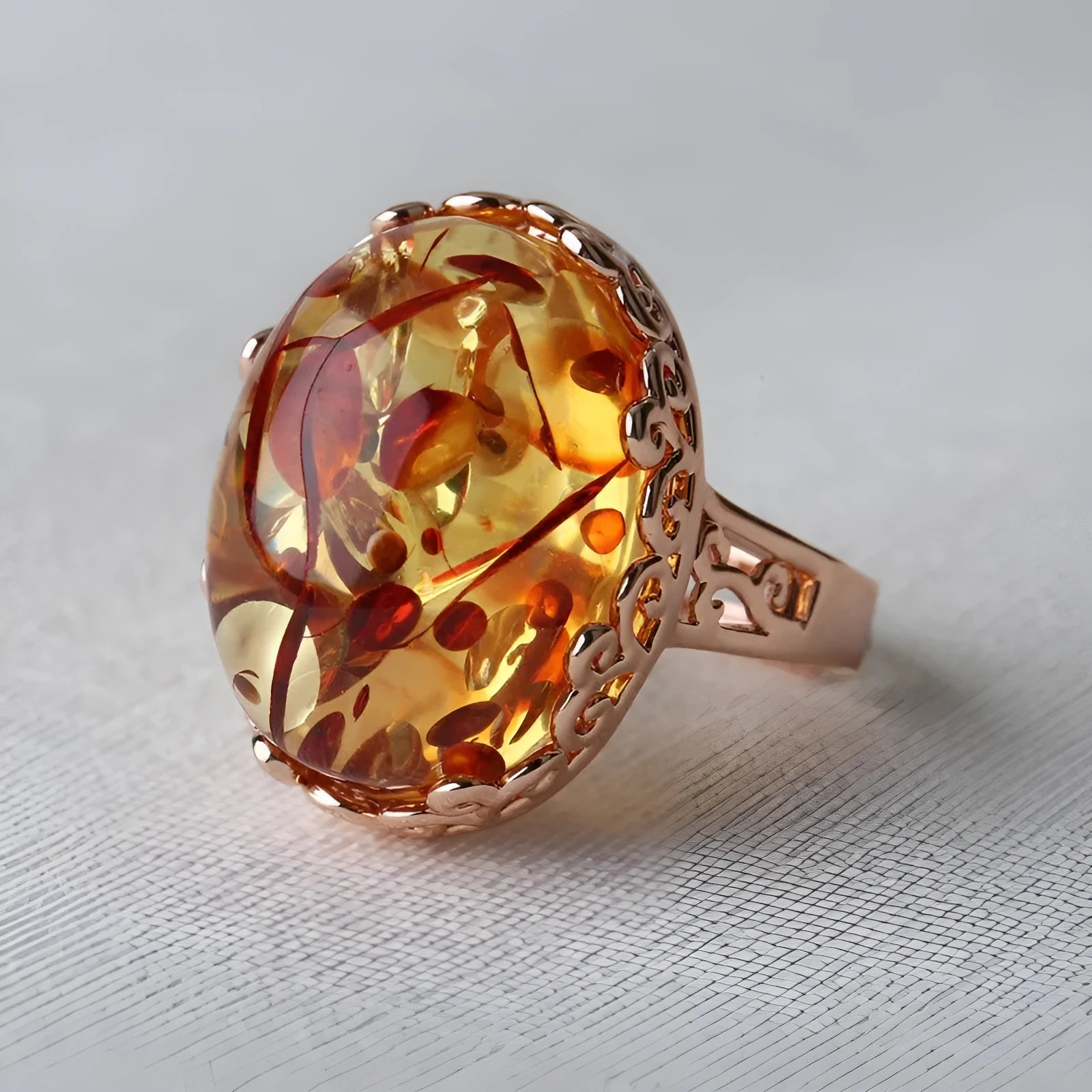 Beeswax coloured amber ring with ethnic retro design on an alloy band.
