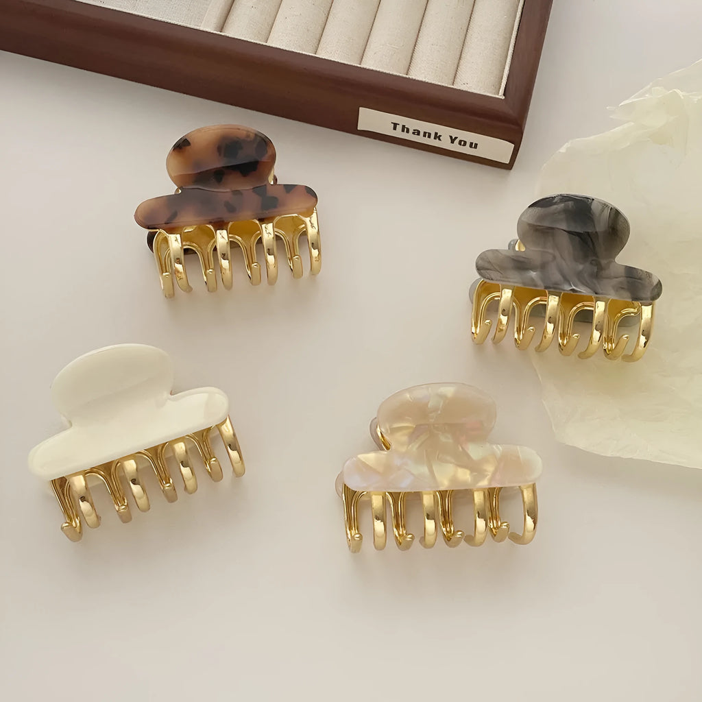 Retro acetate hair grip with metal clamp in medium size, showing irregular pattern on surface