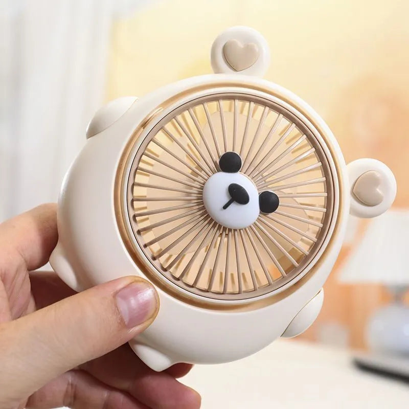 Cute dog-themed USB desktop electric fan in one of six colour options on a desk.