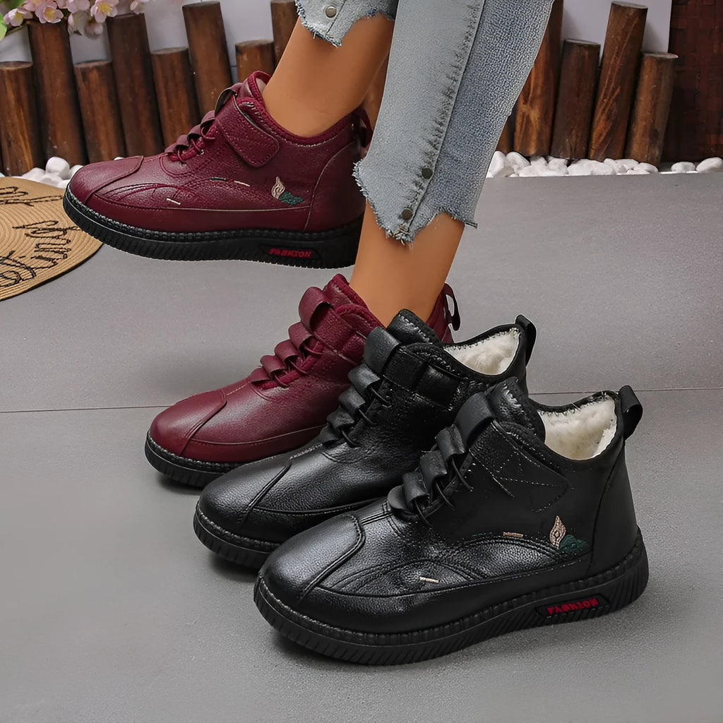 Black and red women's velvet indoor shoes with rubber soles and low tube socks design.