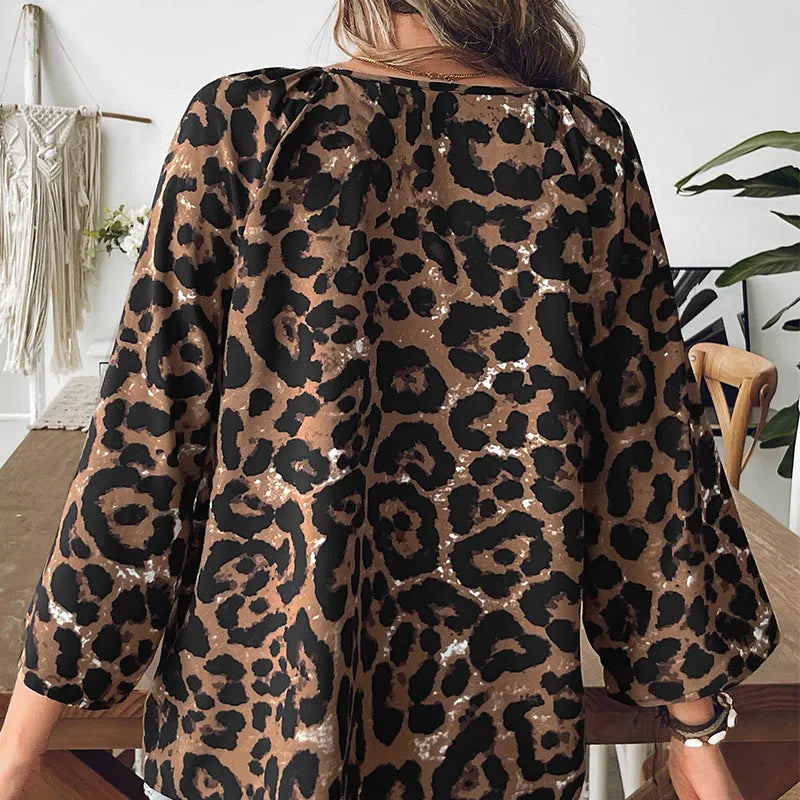 Women's multicolour leopard print V-neck pullover top with half sleeves on a hanger.