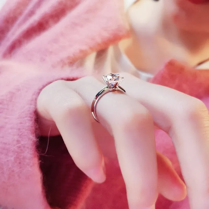 White gold plated six-claw zircon ring with geometric design on a white copper band.