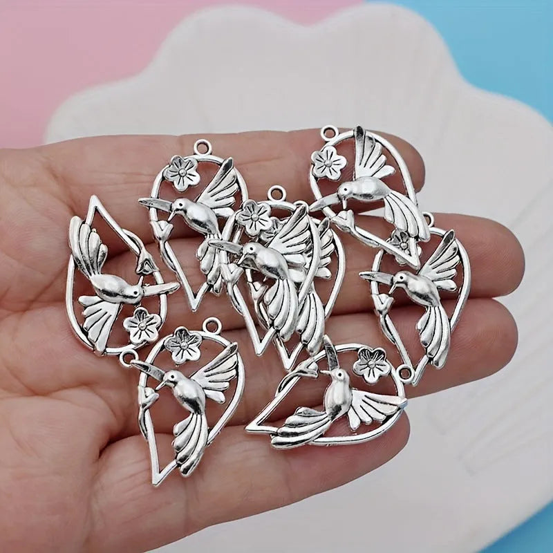 Alloy magpie bird pendant charm with electroplated finish on a white background.