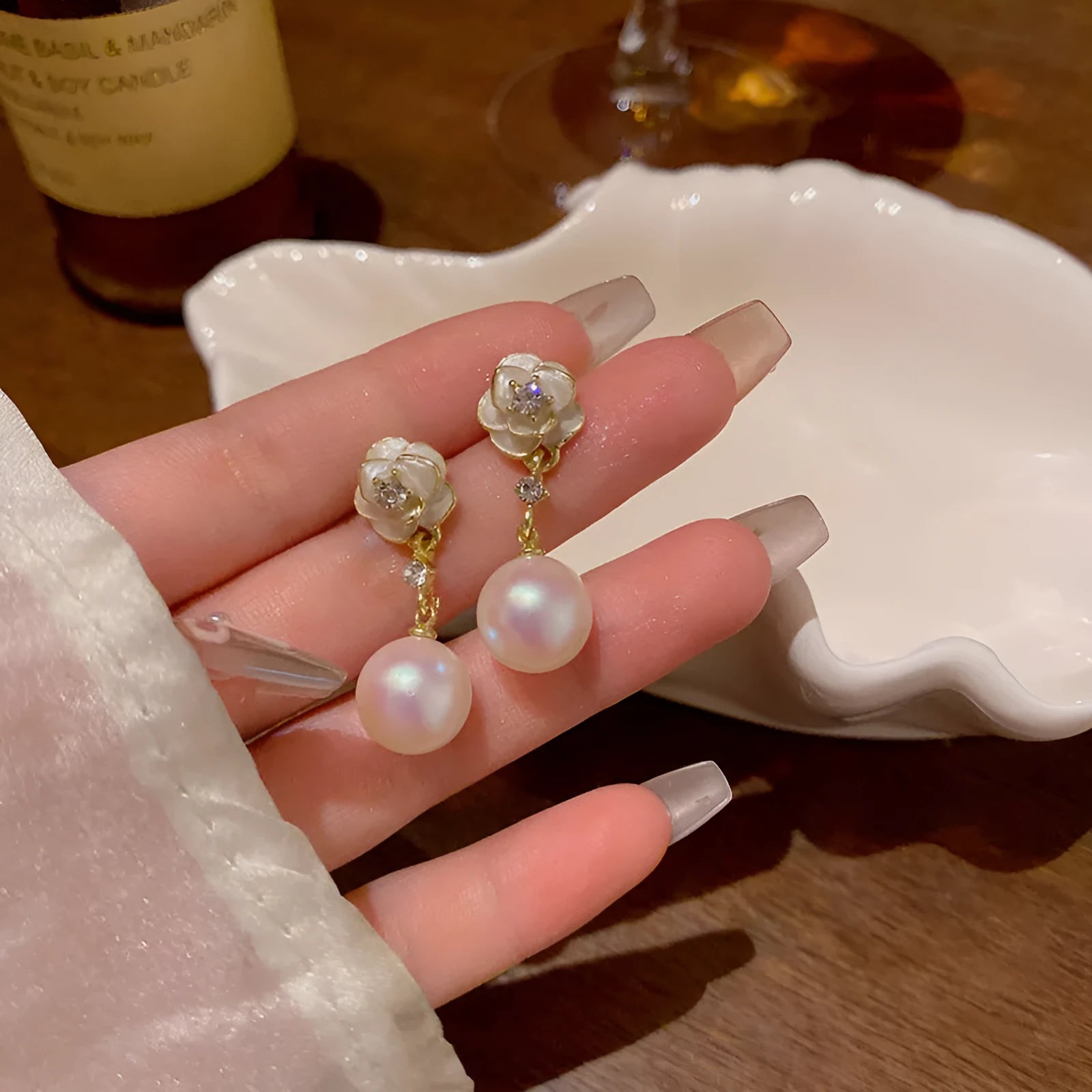 A pair of women's alloy stud earrings shaped like a detailed camellia flower in a 'Camellia' colour.