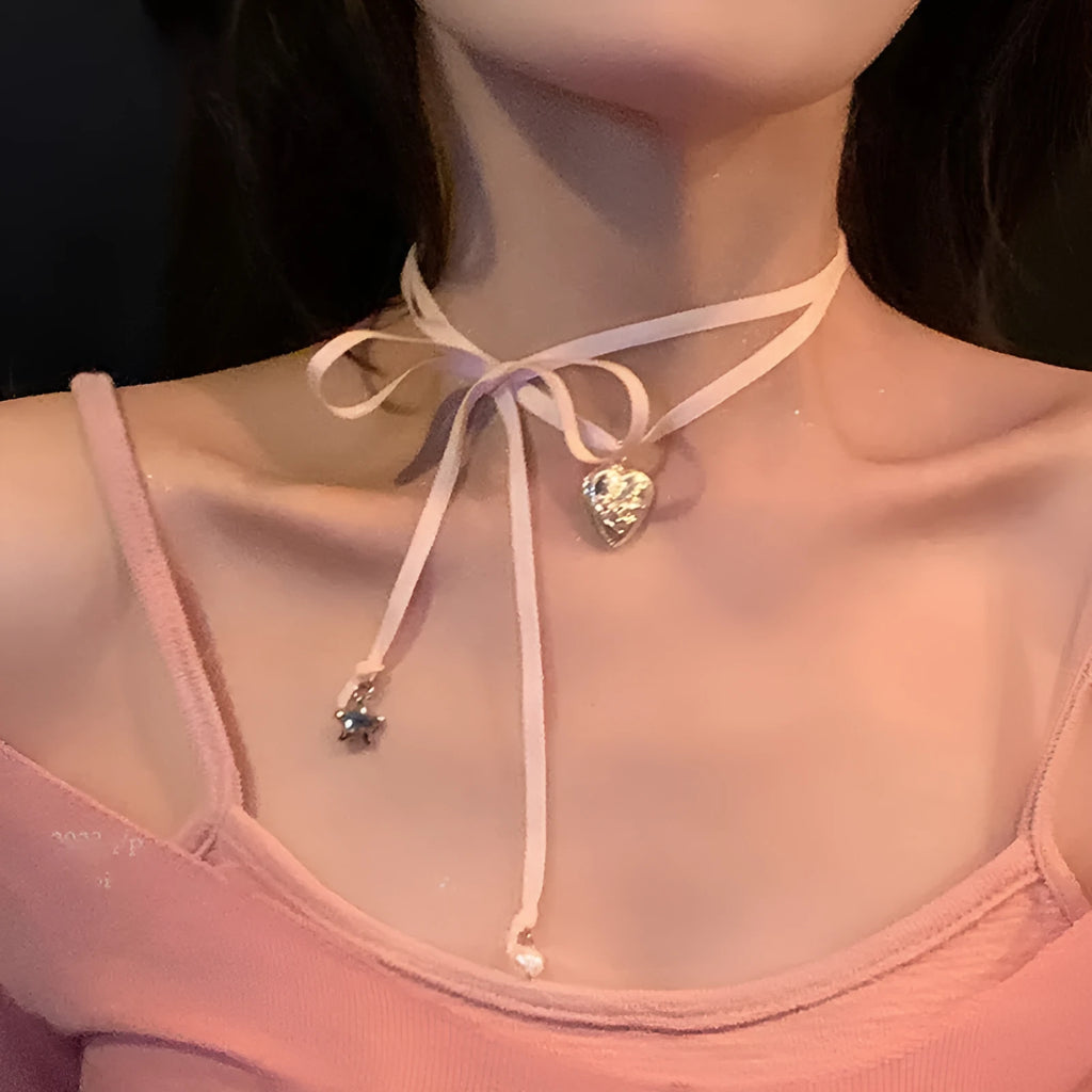 Women's ribbon love pendant fashion necklace in alloy with electroplated finish on clavicle chain.