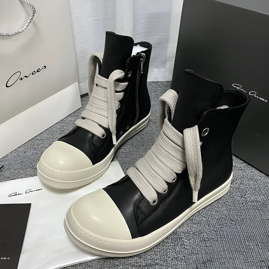 Black genuine leather high-top sneakers with side zip and stitching details on round toe design