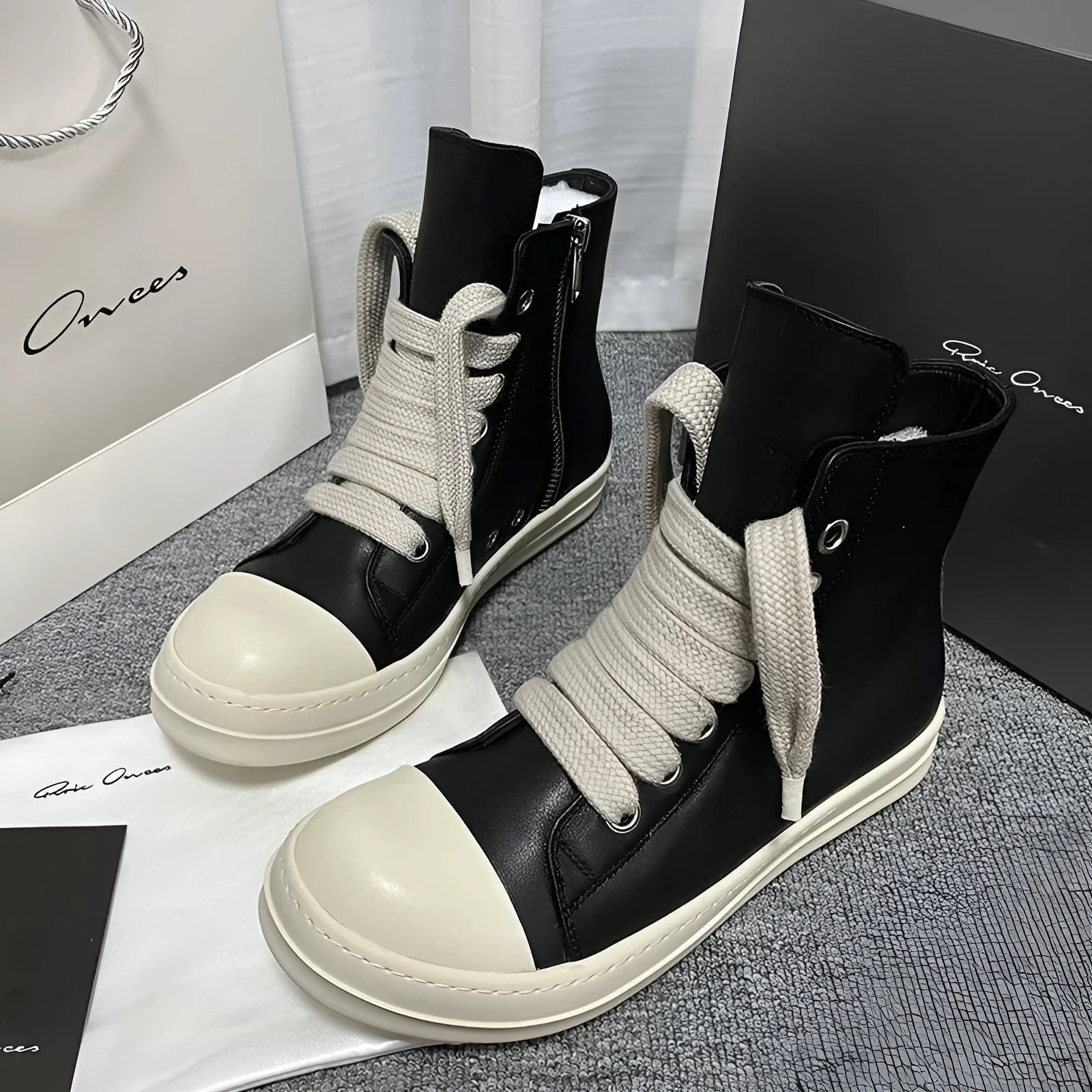 Black genuine leather high-top sneakers with side zip and stitching details on round toe design