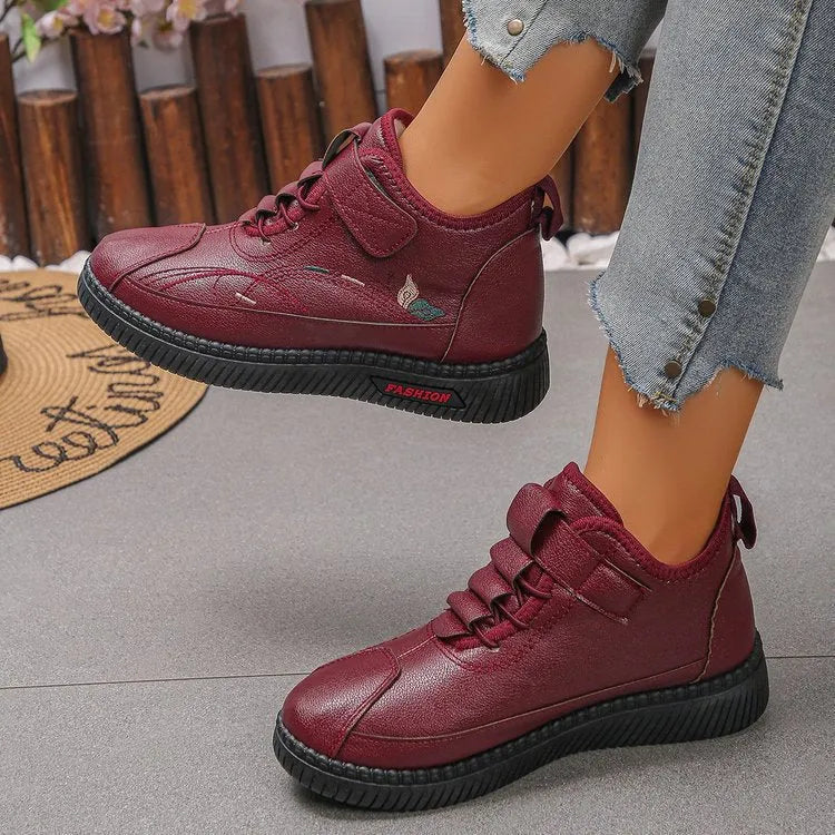 Black and red women's velvet indoor shoes with rubber soles and low tube socks design.