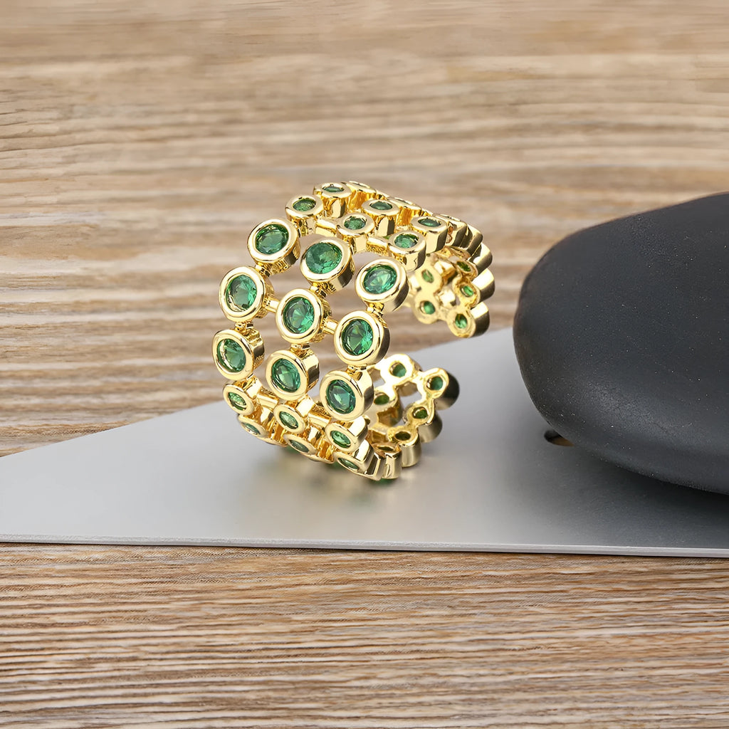 Copper ring with gold plating and green zircon stones in wide band design