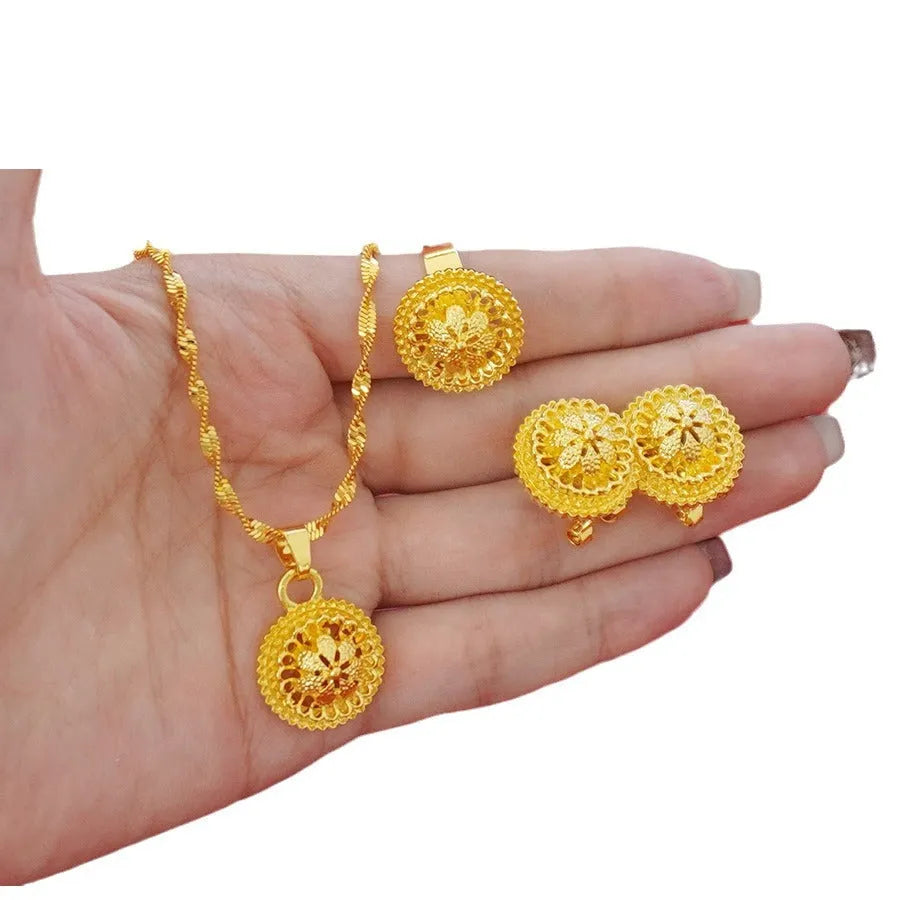 Gold electroplated three-piece jewellery set with floral designs, water wave chain necklace, matching earrings and ring
