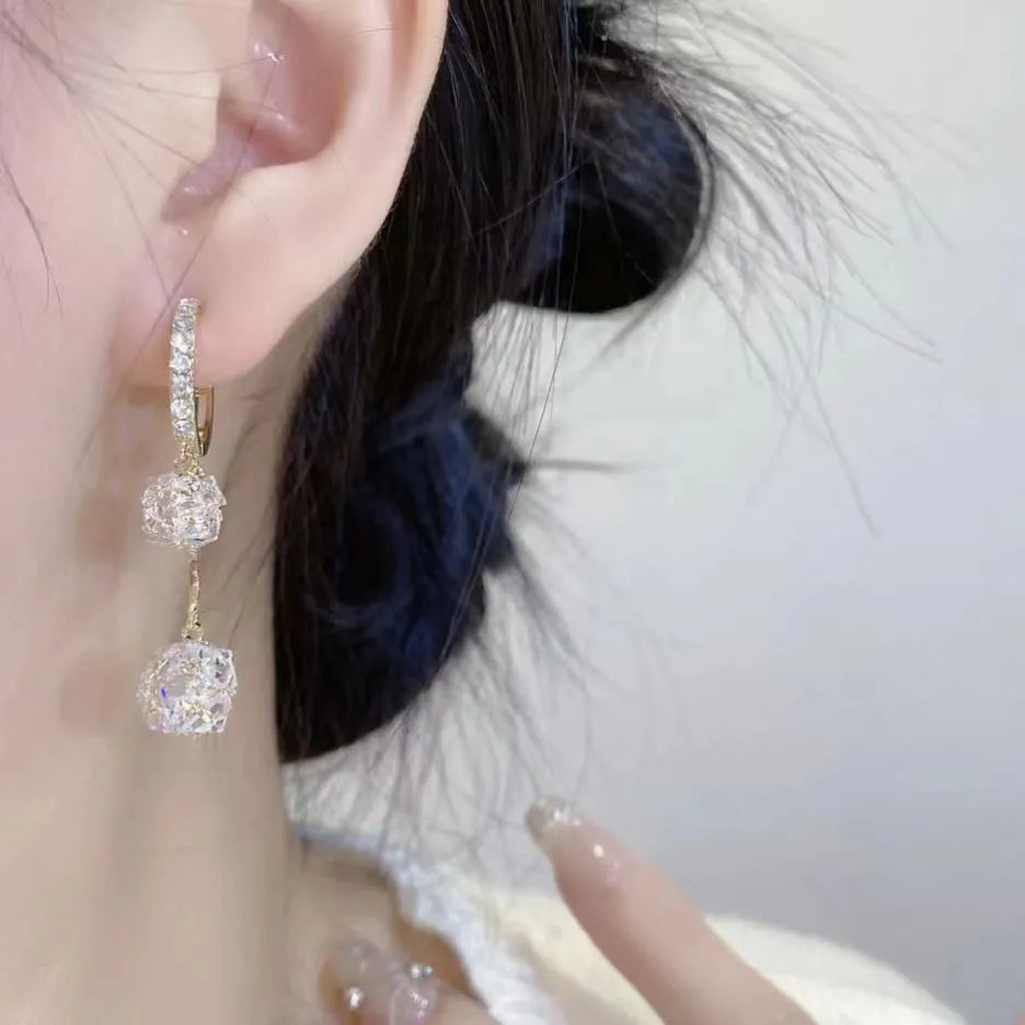 Women's silver drop earrings with tassel ball and rhinestone ball double pendant design, clip-on fastening