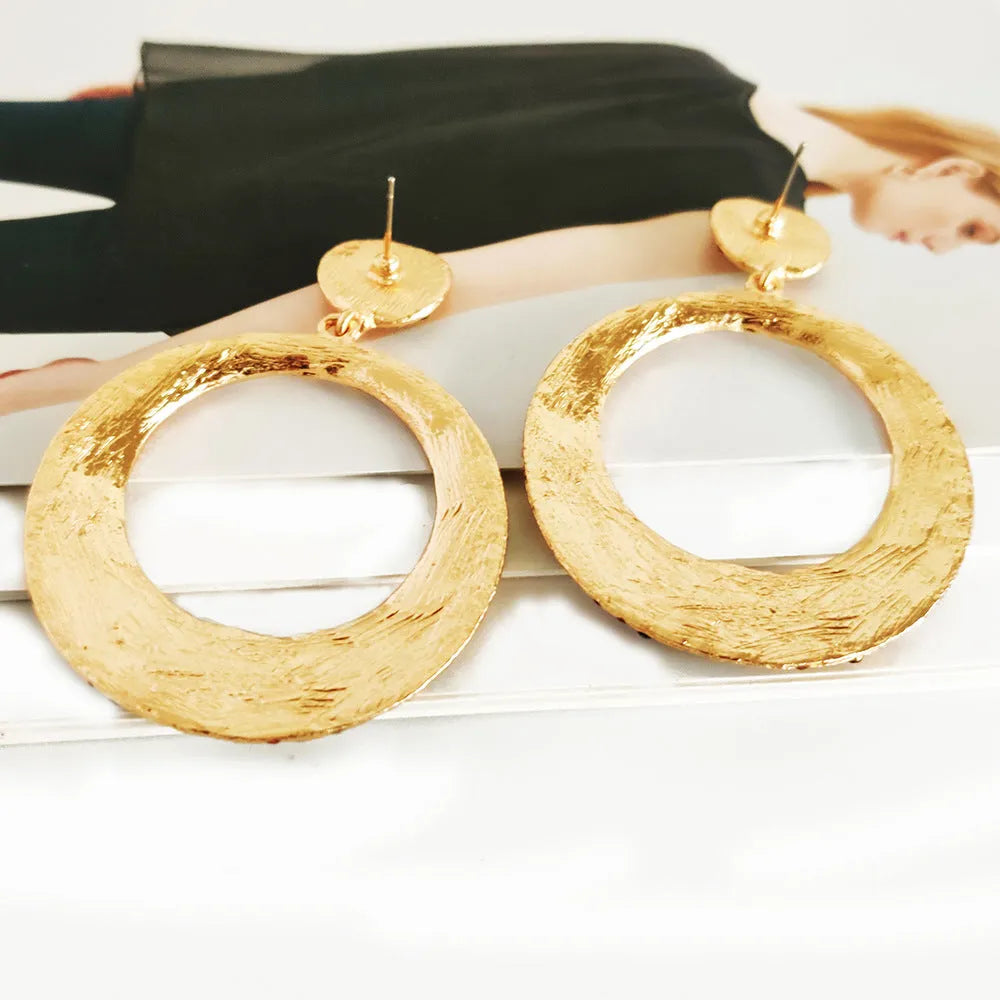 Colourful alloy metal earrings with large round diamond-look pendants in cartoon style