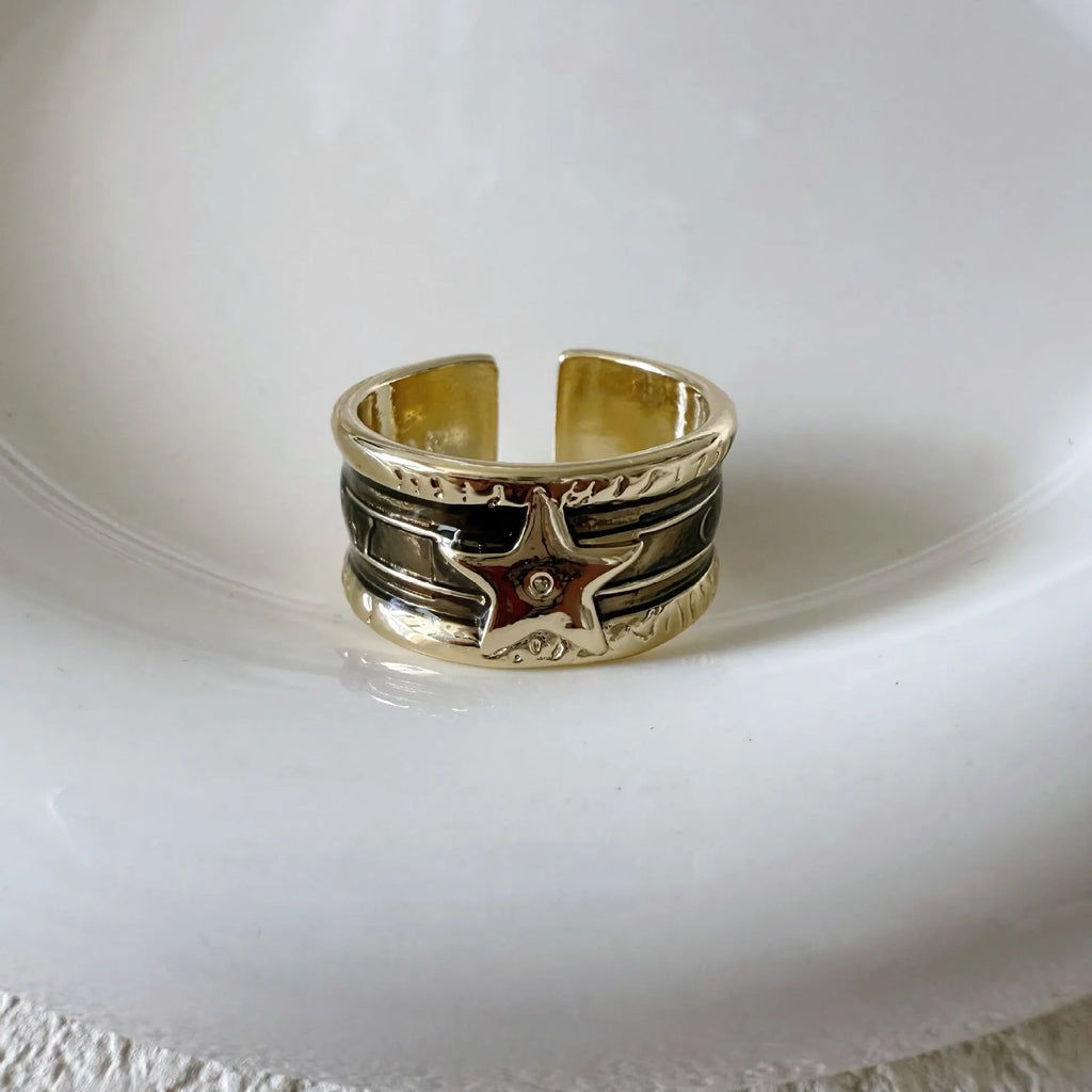 Adjustable geometric drop oil ring for women in copper with distressed finish and lines pattern