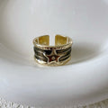 Adjustable geometric drop oil ring for women in copper with distressed finish and lines pattern