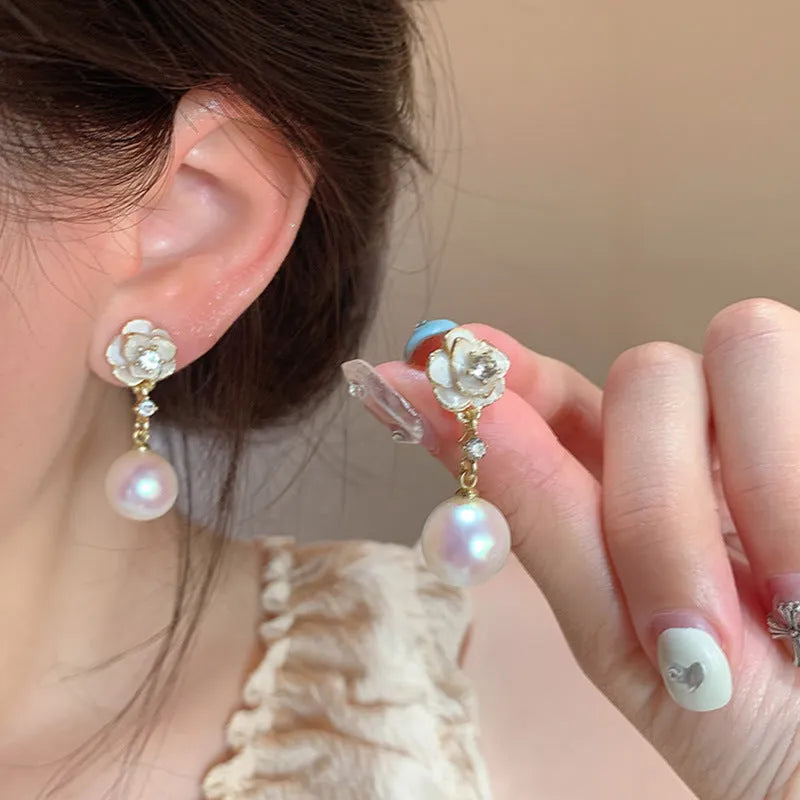 A pair of women's alloy stud earrings shaped like a detailed camellia flower in a 'Camellia' colour.