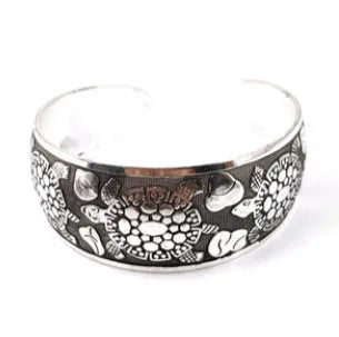 Carved openwork Miao ethnic bracelet in alloy with diamond-cut treatment showing detailed patternwork