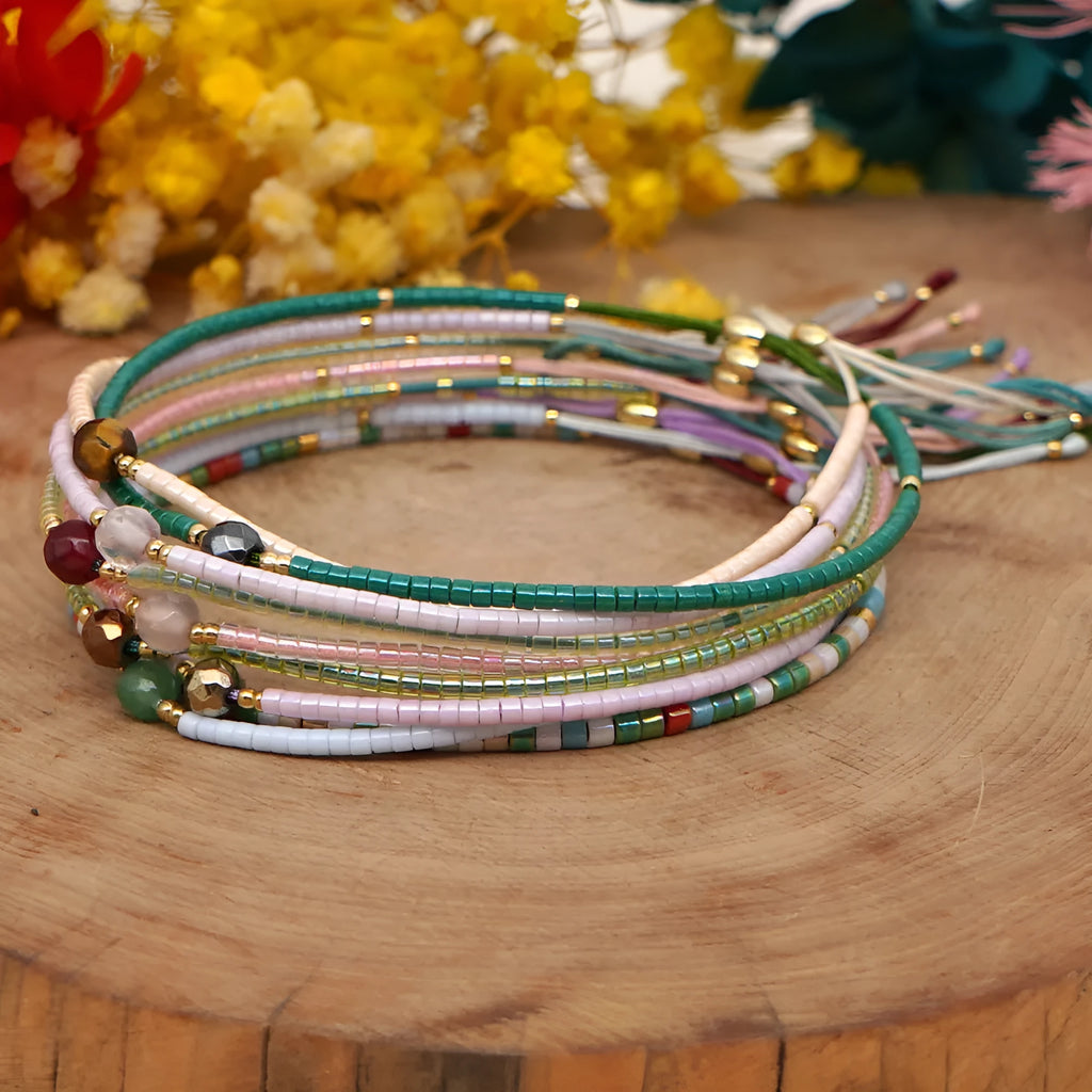 Handmade Bohemian-style women's bracelet with colourful geometric glass beads and lucky stone charms.