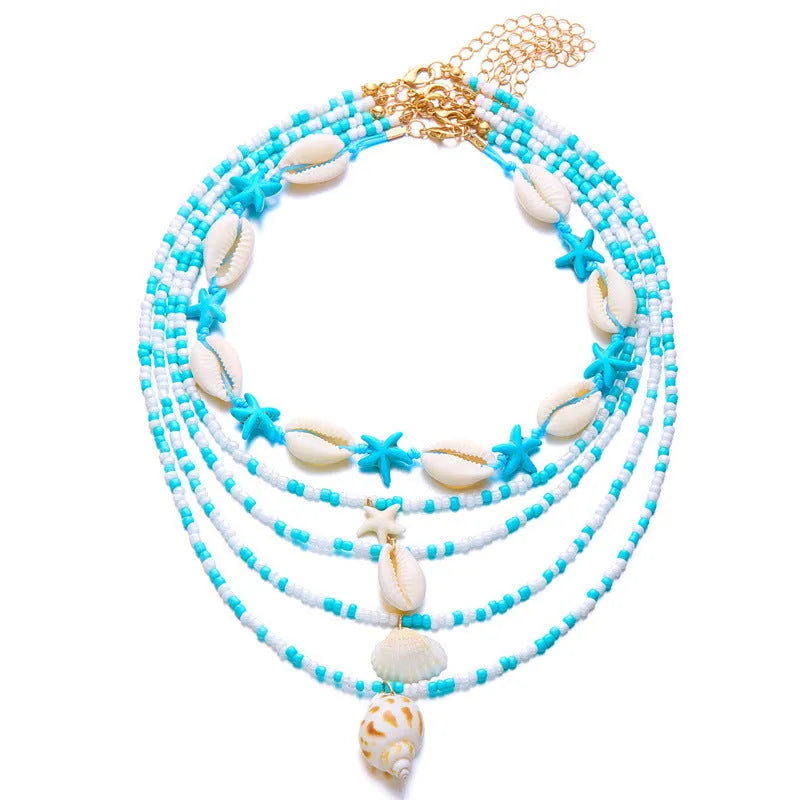 Blue and coloured women's summer necklace set with starfish, shell, and conch bead pendants on beaded chains