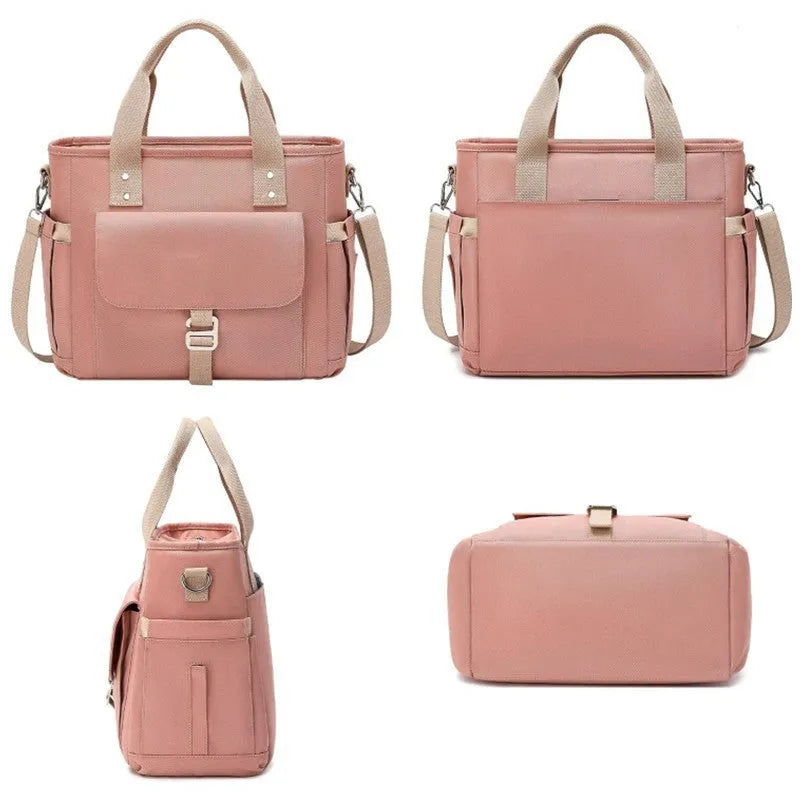 A portable cube-shaped picnic bag with a removable shoulder strap and a side pocket, shown in pink colour.