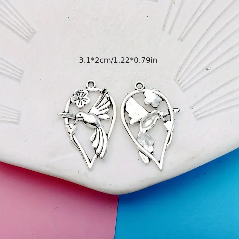 Alloy magpie bird pendant charm with electroplated finish on a white background.