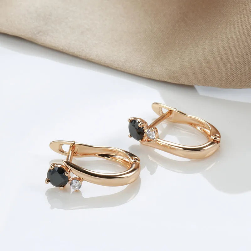 Gold geometric drop earrings with black agate stone styling