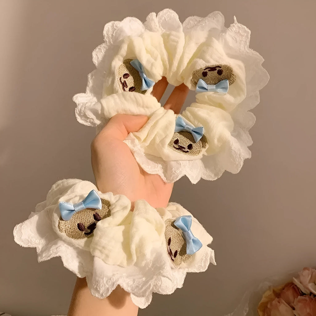 Close-up of a blue cloth hair ring with a cute bear and bow design, showing its large intestine loop style.
