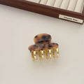 Retro acetate hair grip with metal clamp in medium size, showing irregular pattern on surface