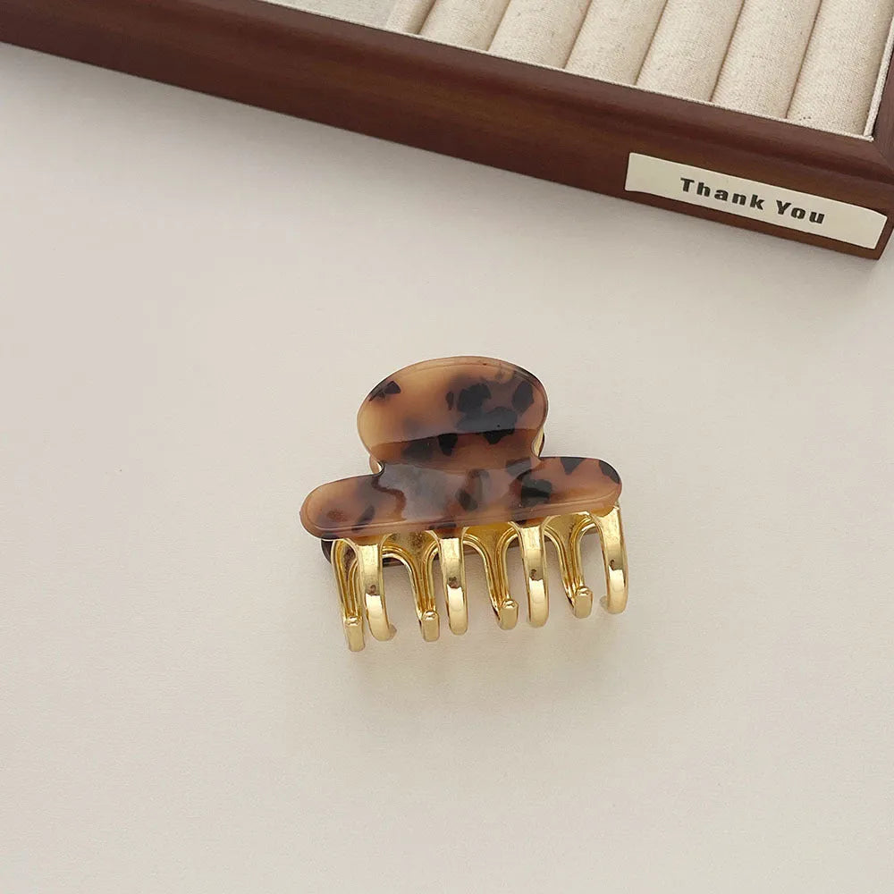 Retro acetate hair grip with metal clamp in medium size, showing irregular pattern on surface