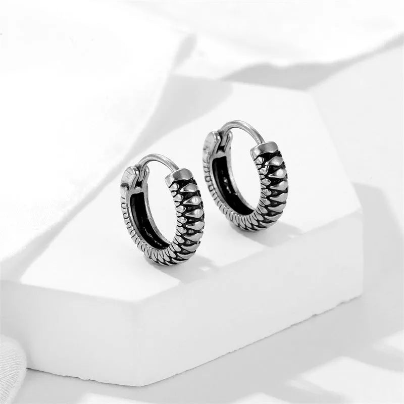 Silver geometric alloy earrings with a retro twist design and stainless steel stripes.