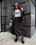 Women's solid colour cotton long skirt with elasticated waistband in black and white.
