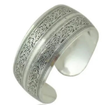 Carved openwork Miao ethnic bracelet in alloy with diamond-cut treatment showing detailed patternwork