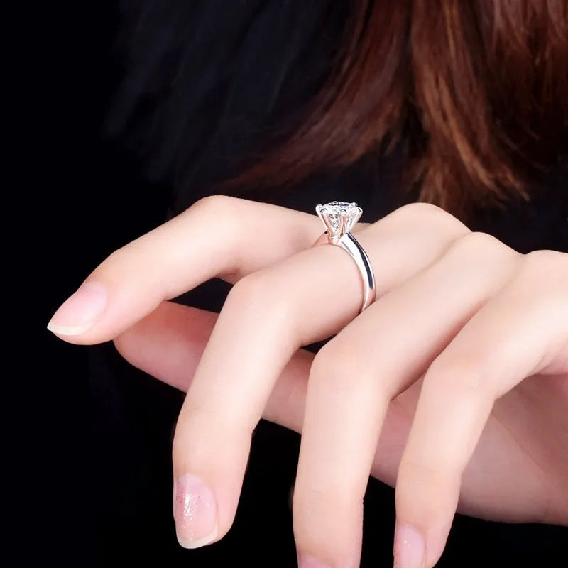White gold plated six-claw zircon ring with geometric design on a white copper band.