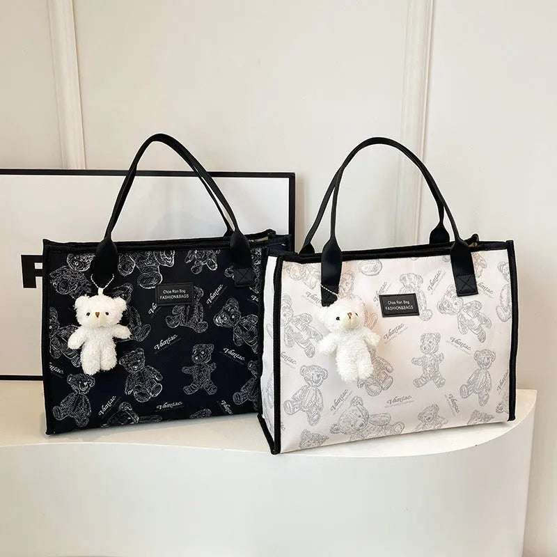 Women's black and white printed canvas tote bag with rhombus pattern showing large capacity and shoulder strap