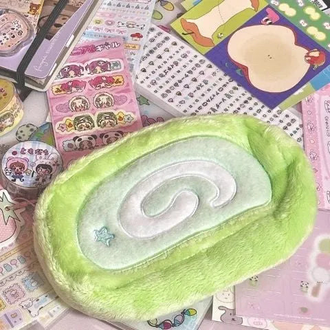 Velvet pencil case with a Swiss roll cake design, shown in a rolled-up position.
