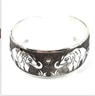 Carved openwork Miao ethnic bracelet in alloy with diamond-cut treatment showing detailed patternwork