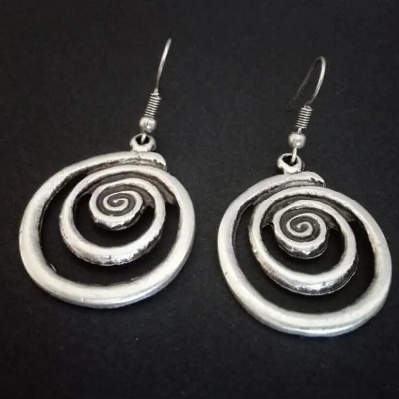 Silver alloy geometric spiral earrings with a distressed finish, measuring 2.6cm by 5cm.