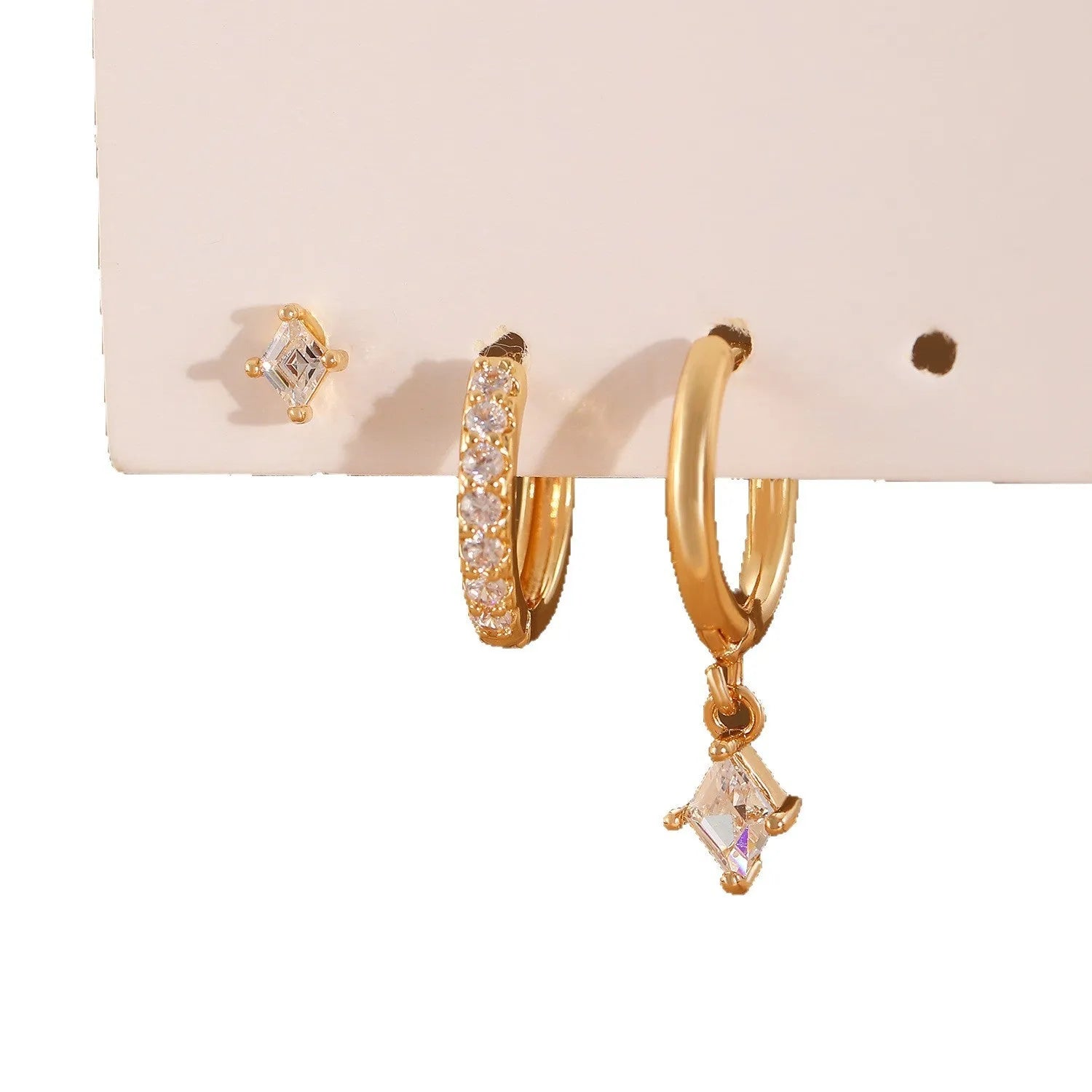 Gold and white geometric earring set with zircon stones showing three earring types: dangling, stud, and clasp.