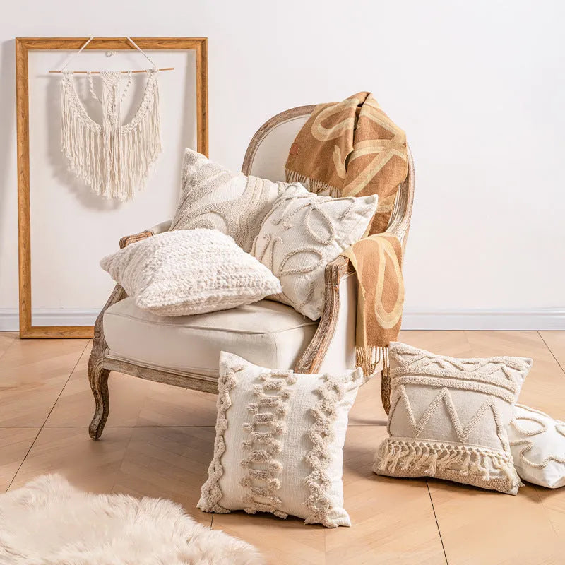 Knitted decorative pillow cover with tassels in a striped print design.